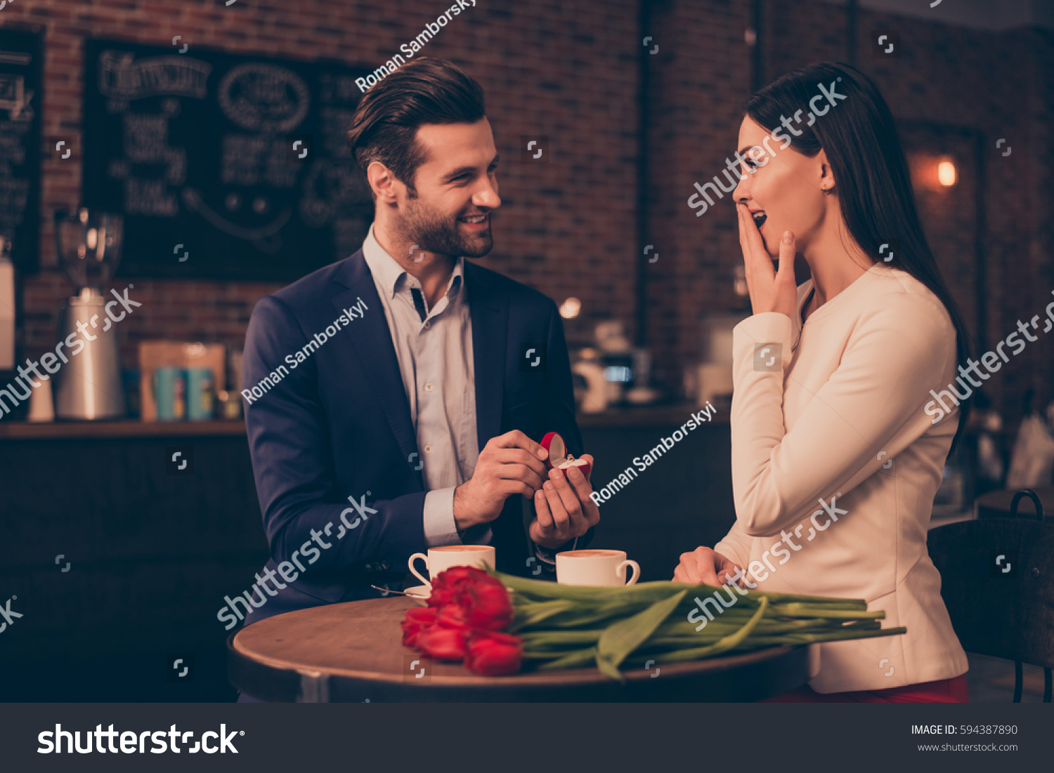 A happy man making proposal in a cafe #594387890