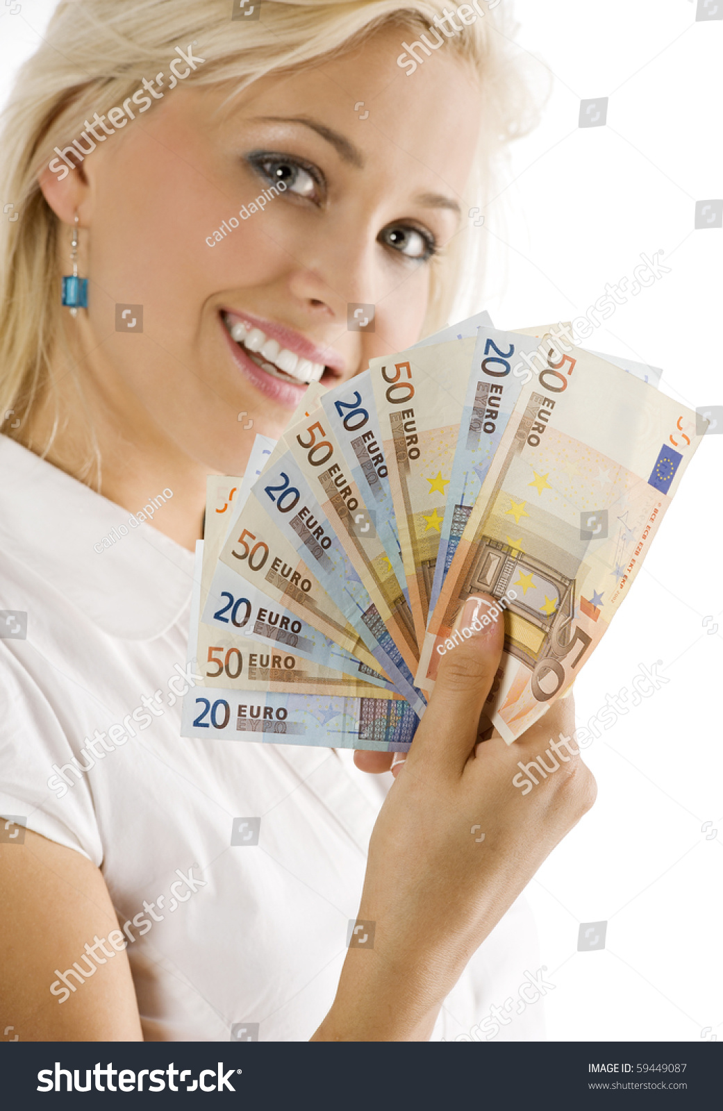 smiling girl keeping a fan of euro cash . FOCUS ON THE MONEY . FACE NOT IN FOCUS #59449087