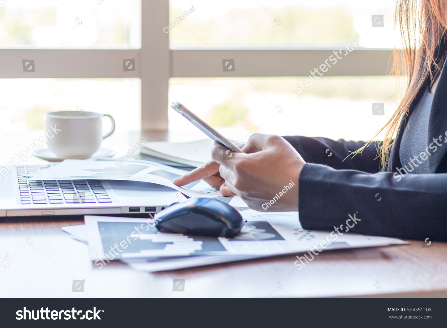 Close Up businessmen working at a coffee shop with a document with a smartphone and a laptop computer. #594551108