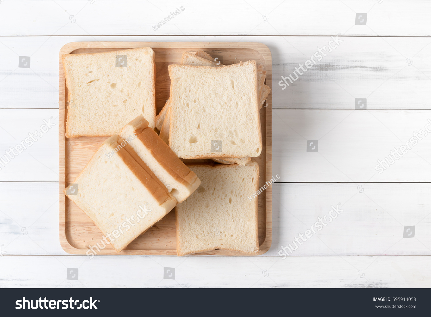 white sliced bread on wood plate and white wood background, top view and copy space. #595914053