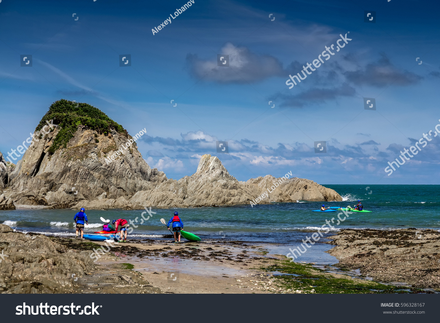 Lee Bay on the north coast of Devon. A group of kayakers are preparing to sail. England #596328167