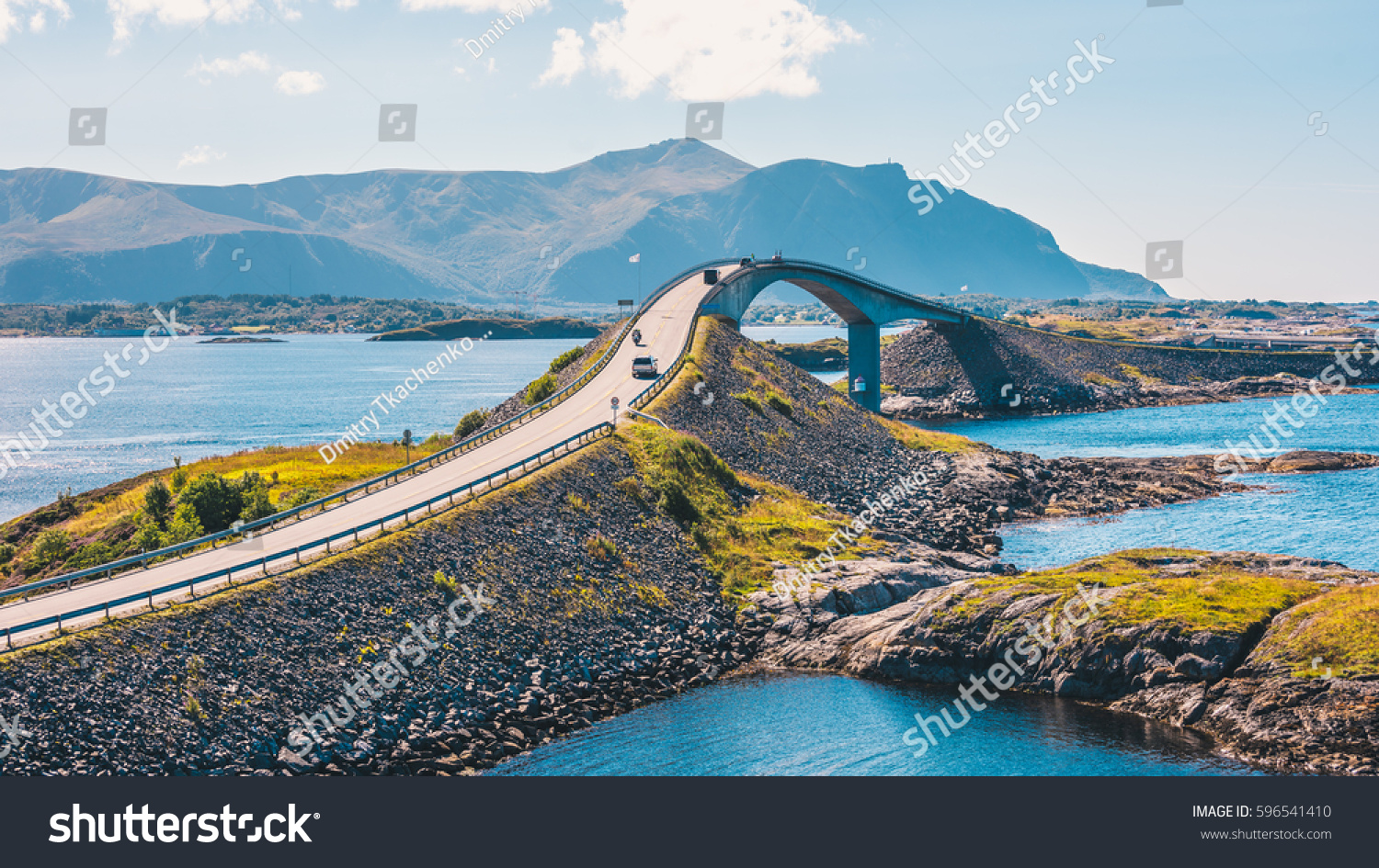 World famous Atlantic road bridge (Atlanterhavsvegen) with an amazing view over the norwegian mountains. Atlantic road runs through an archipelago in Eide and Averøy in Møre og Romsdal, Norway. #596541410