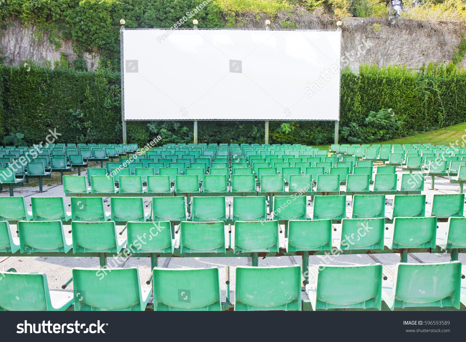 Outdoor cinema with white projection screen #596593589