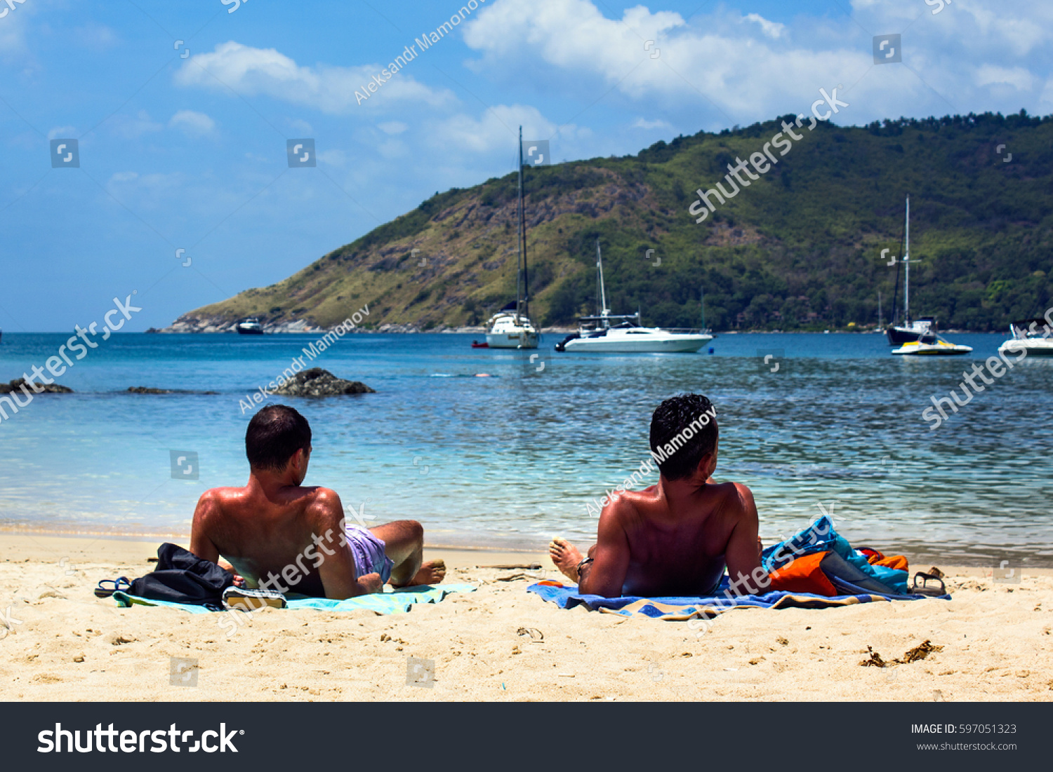 Gay Men Couple Tanning On The Beach Two Men Lying On The Beach Taking Sunbath Gay Men Couple Tanning On The Beach Two Men Lying On The Beach Taking Sunbath