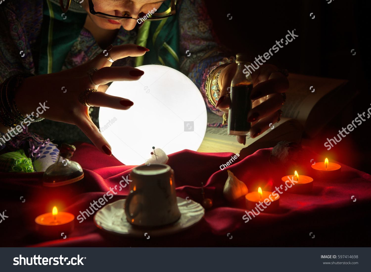 Fortune teller woman staring at crystal ball,potion and witchcraft #597414698