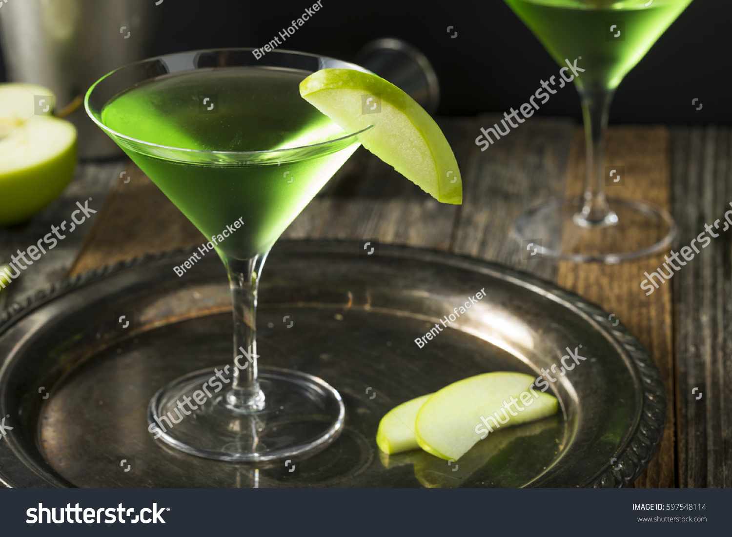 Homemade Green Alcoholic Appletini Cocktail with Apple Garnish #597548114