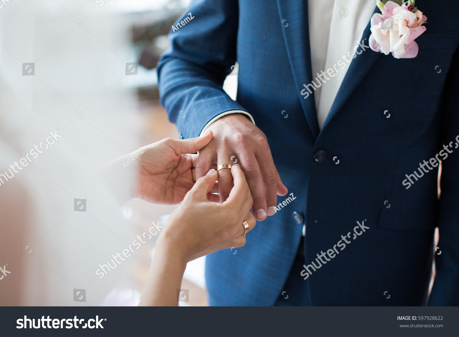 Bride puts ring on groom's finger #597928622