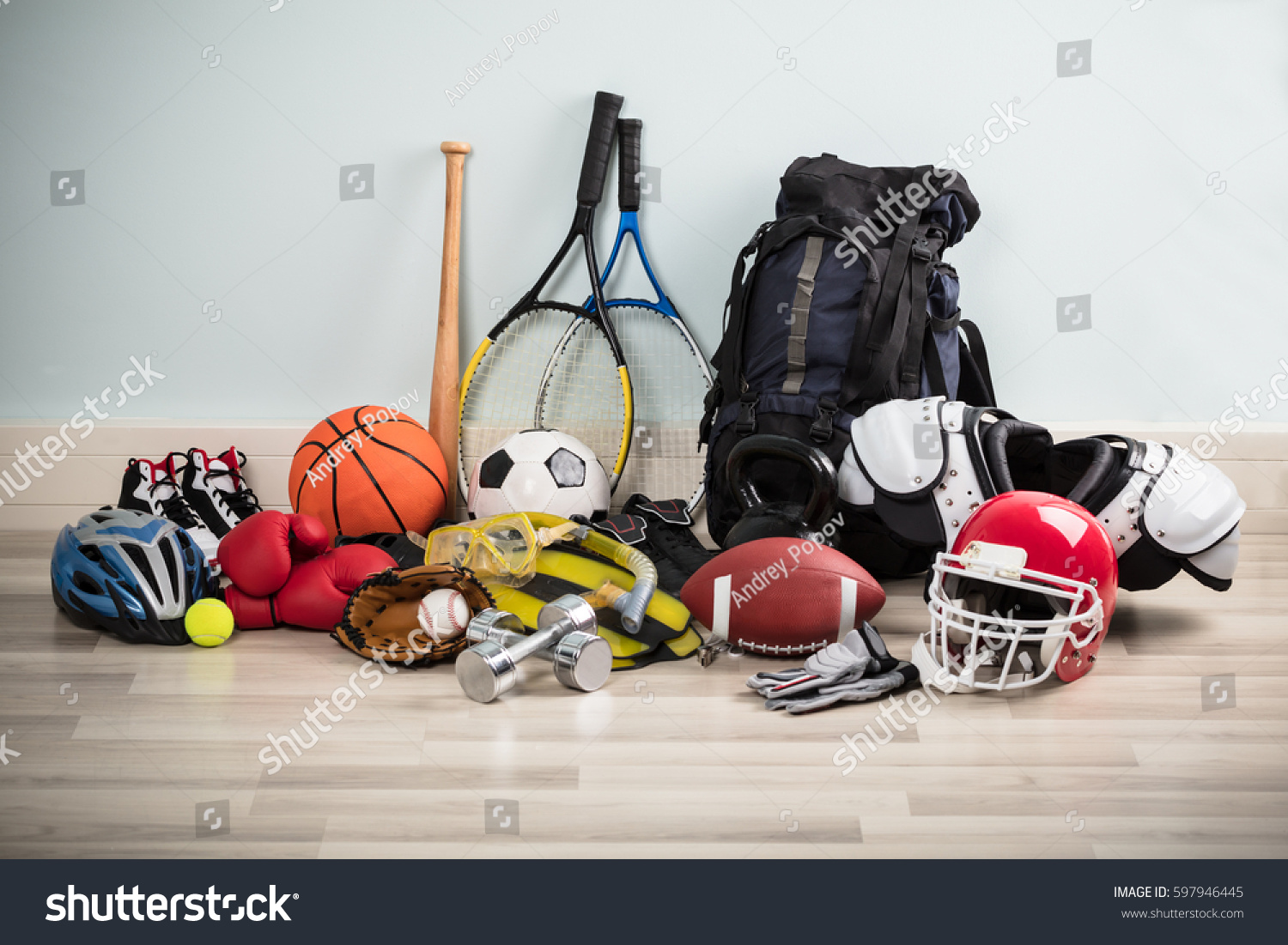 Photo Of Various Sport Equipments On Hardwood Floor #597946445