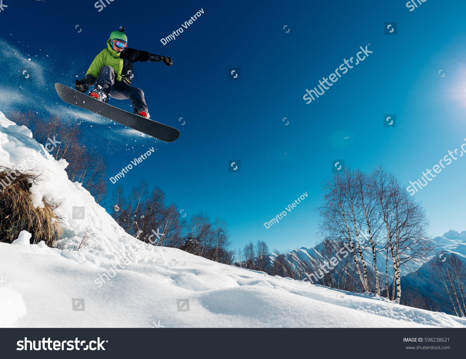 snowboarder is jumping with snowboard from snowhill #598238621