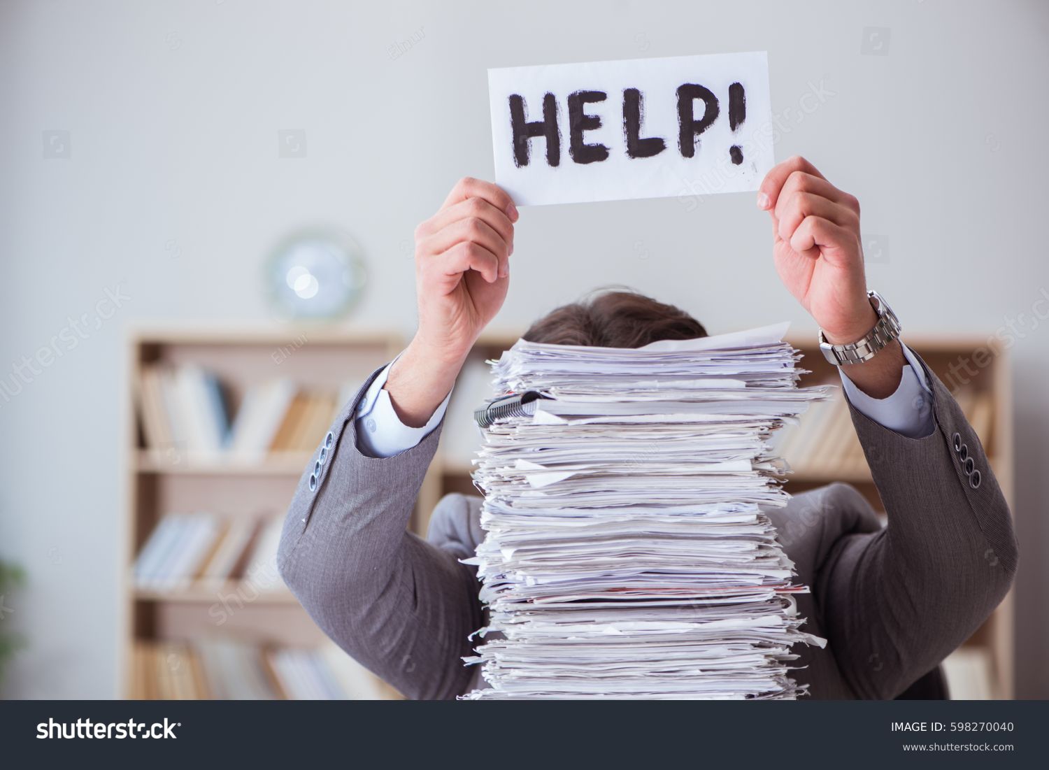 Businessman busy with paperwork in office #598270040