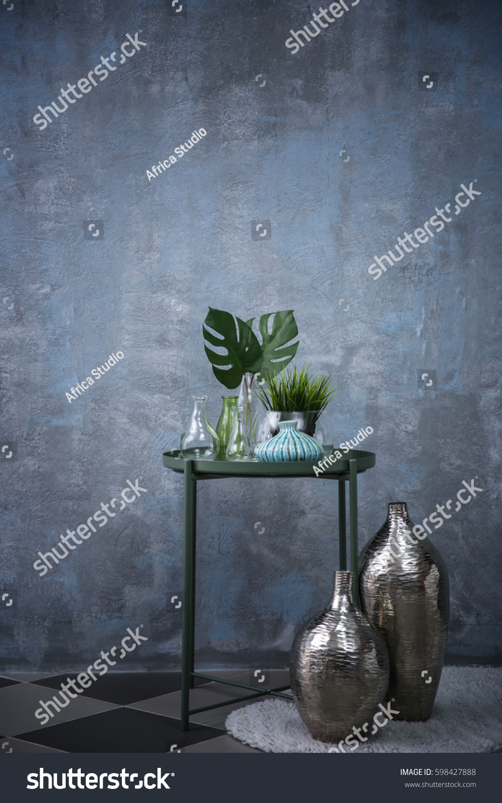 Table with home decor on grey wall background #598427888