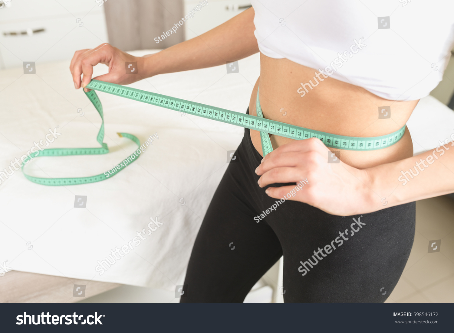 Slim woman measure waist #598546172