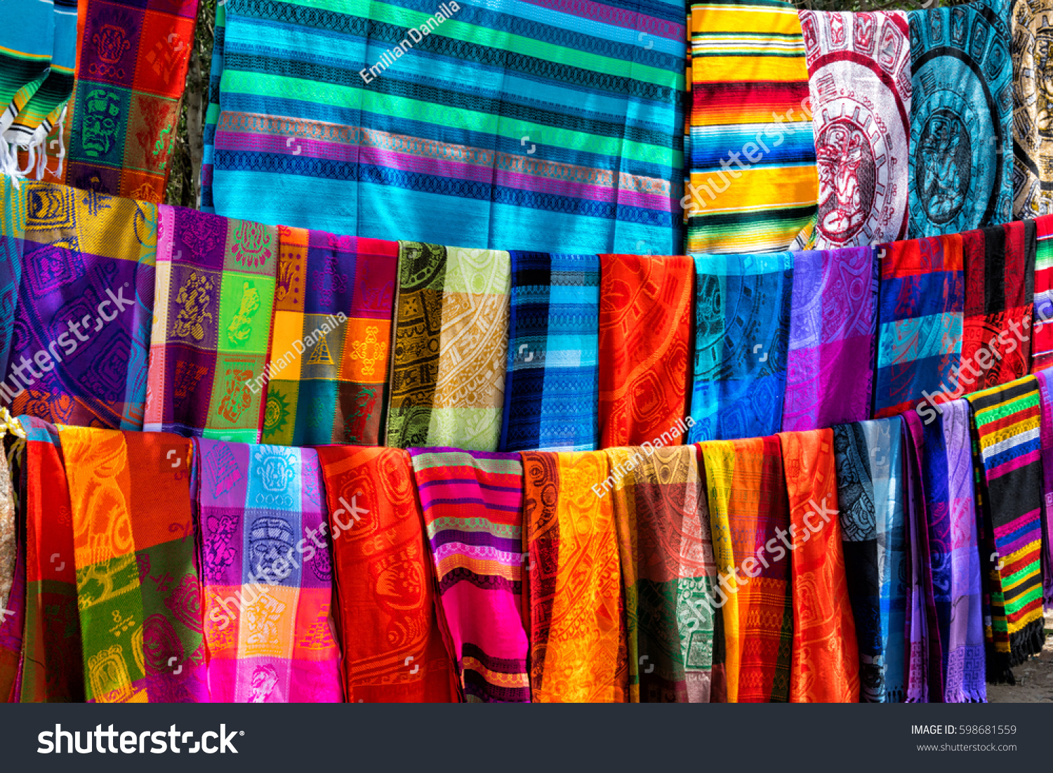Many multicolored textiles being representative for the latin america culture and sold as souvenirs at chichen itza, yucatan mexico. #598681559
