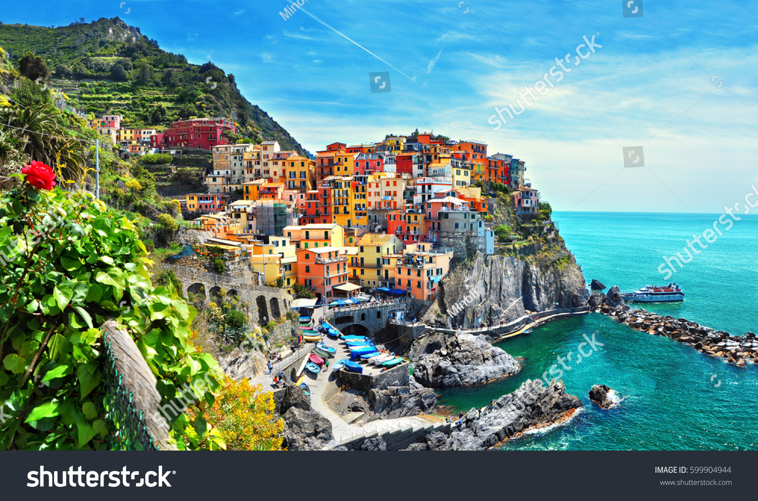 Beautiful view of Manarola town. Is one of five famous colorful villages of Cinque Terre National Park in Italy, suspended between sea and land on sheer cliffs. Liguria region of Italy.  #599904944