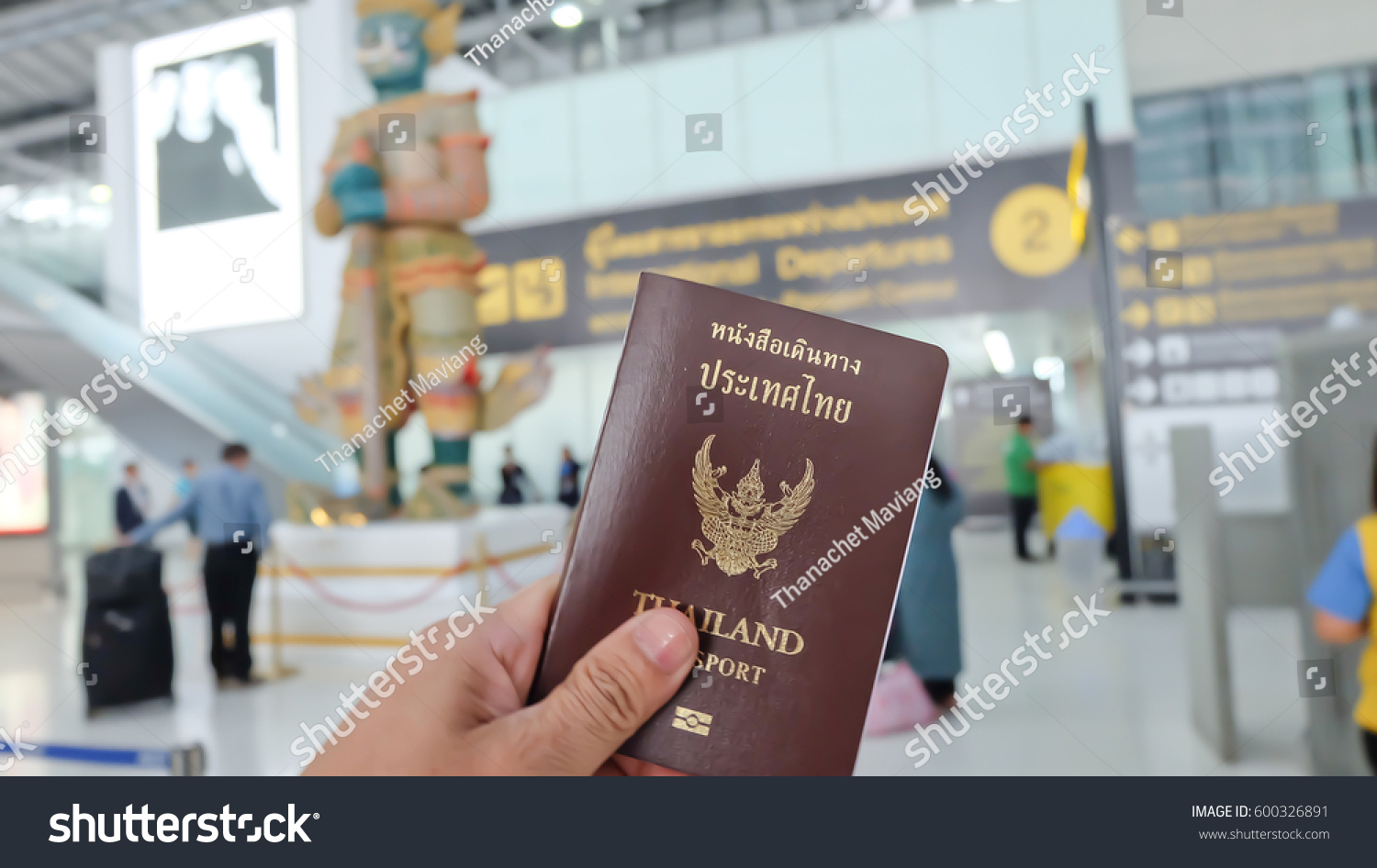 Hand that show the thailand passport at suwannaphum airport. #600326891
