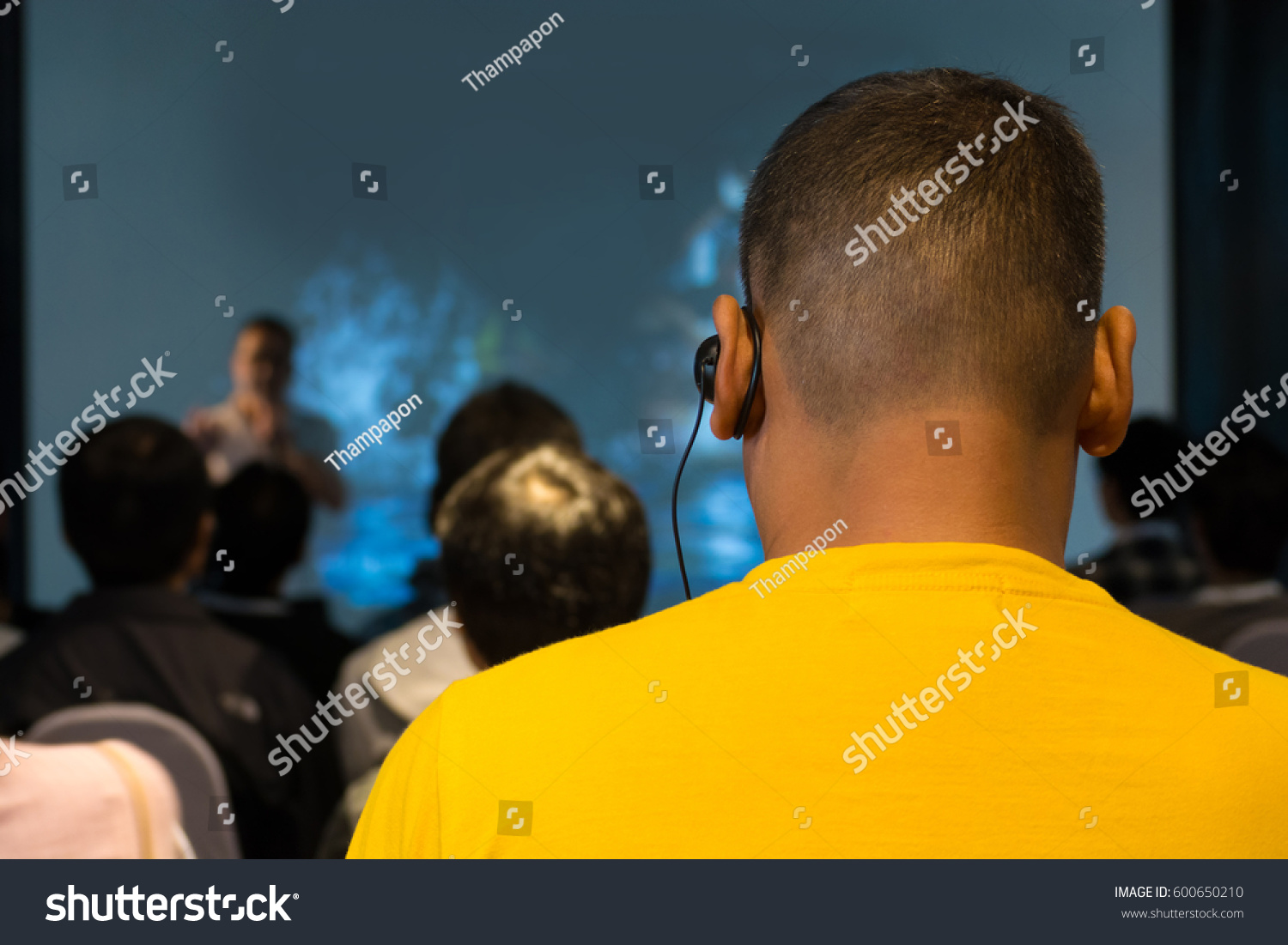 The Male Audience at International Business Meeting or Seminar wearing headphone for online interpreter or Translation as part of Interpretation System #600650210