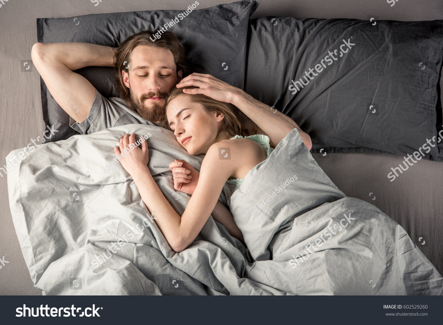 Overhead view of young couple sleeping in bed #602529260