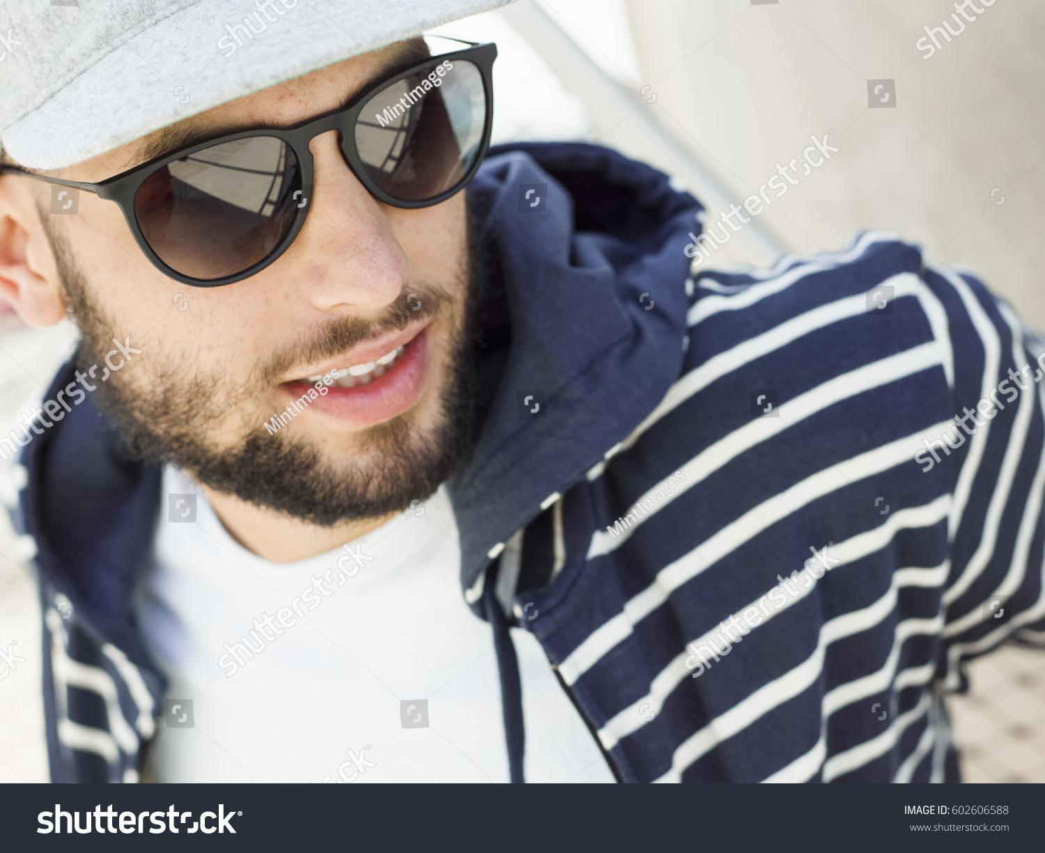 Portrait of a smiling young man wearing sunglasses #602606588