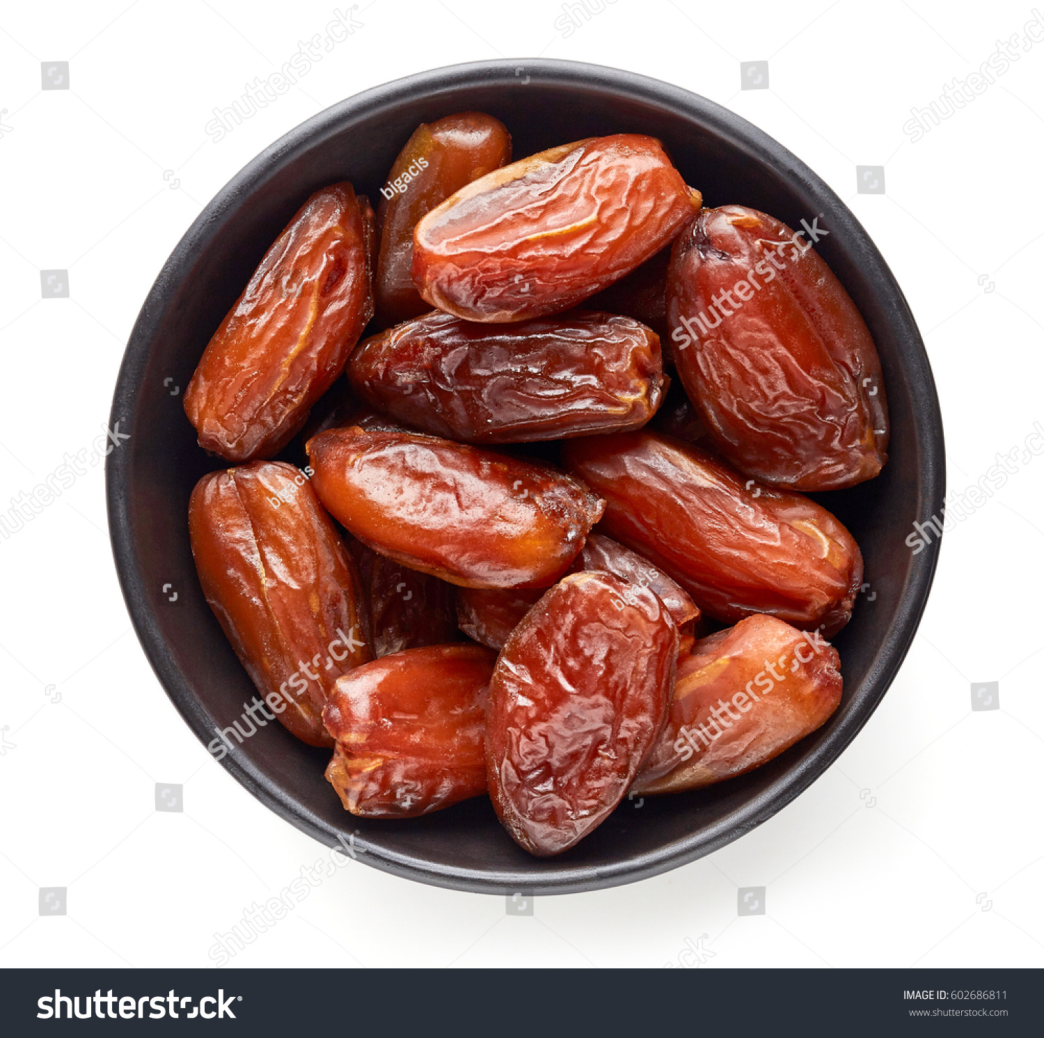 Bowl of pitted dates isolated on white background, top view #602686811