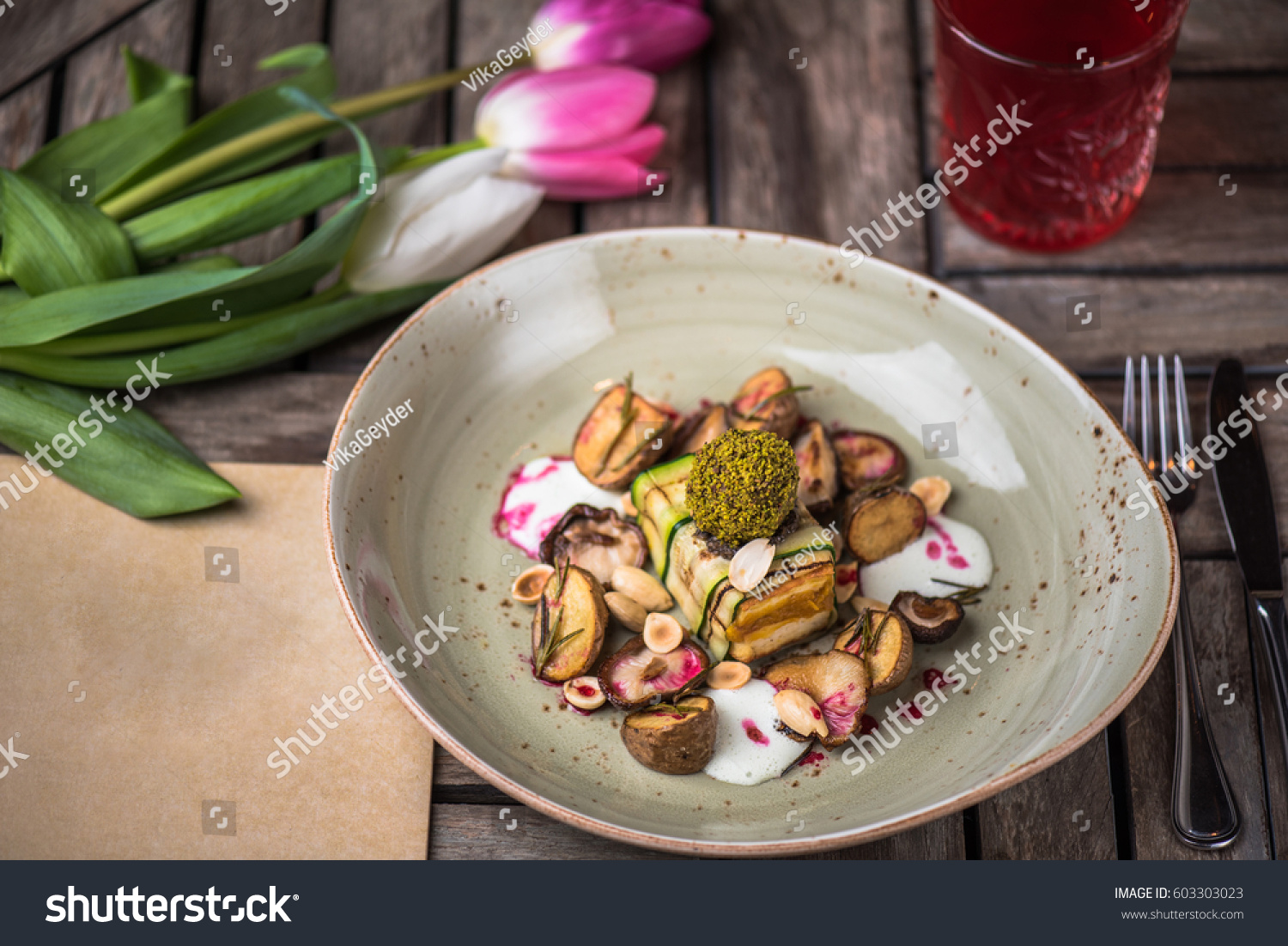 Appetizer of cheese and vegetables, flowers and drink on a wooden table close-up. Healthy food. Vegetarian food. #603303023