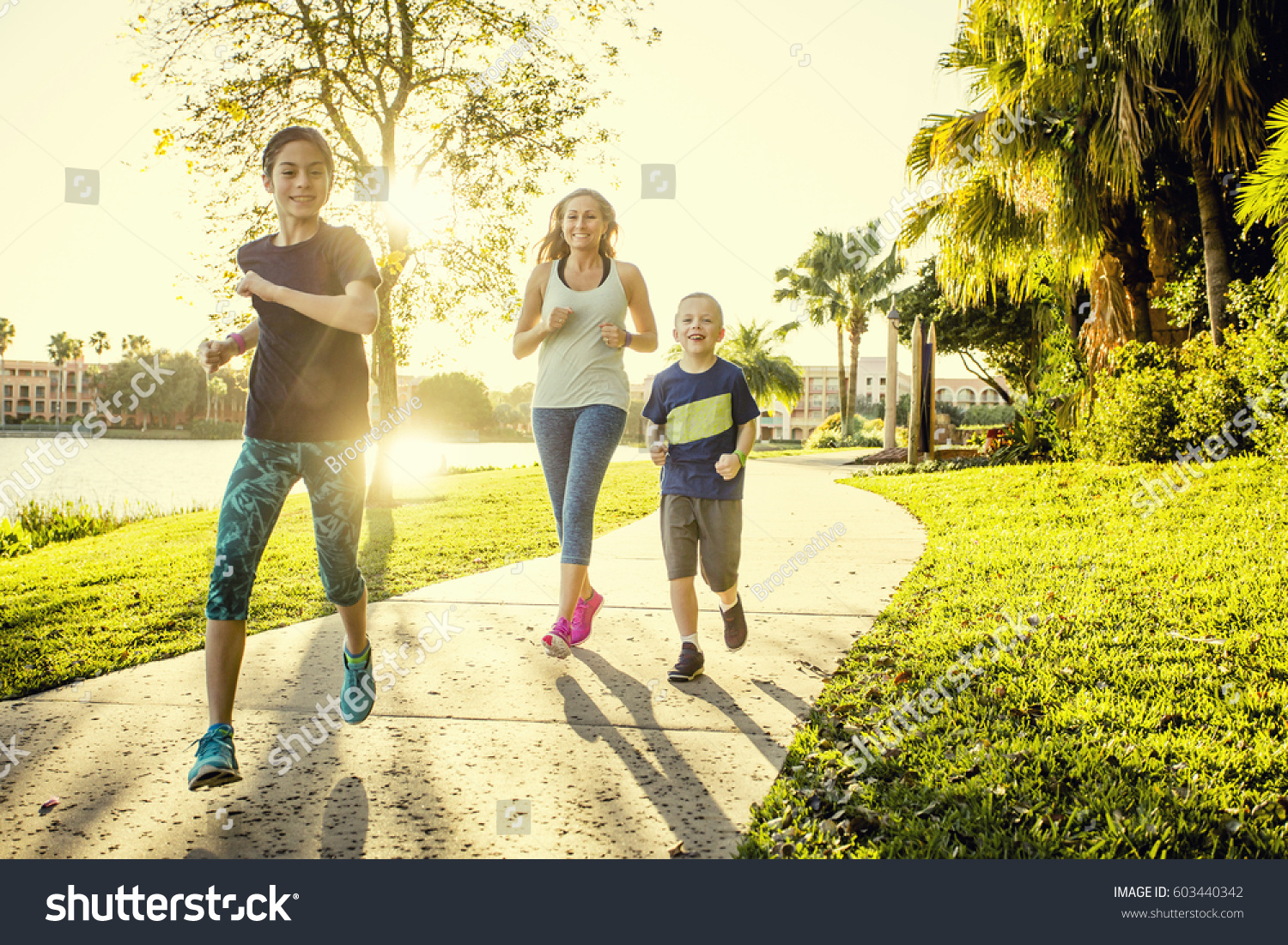 Family exercising and jogging together at the park #603440342
