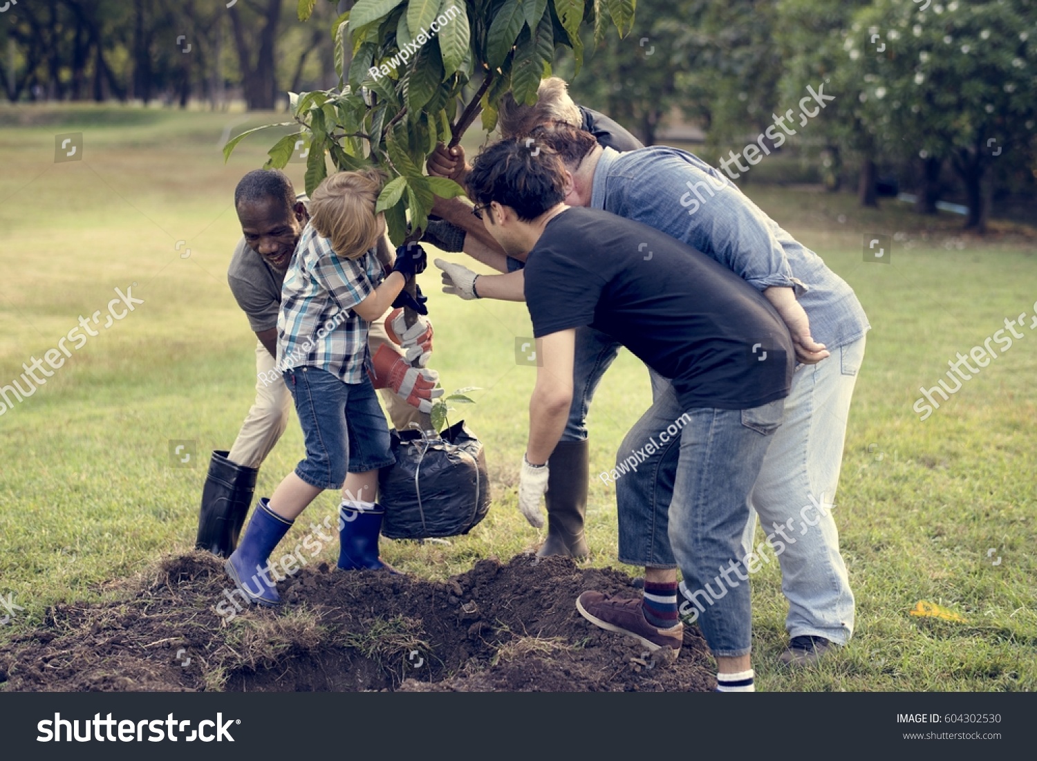 Group of Diverse People Planting Tree Together #604302530