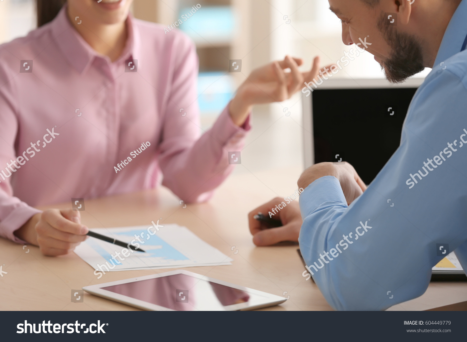 Young managers discussing issues in office #604449779
