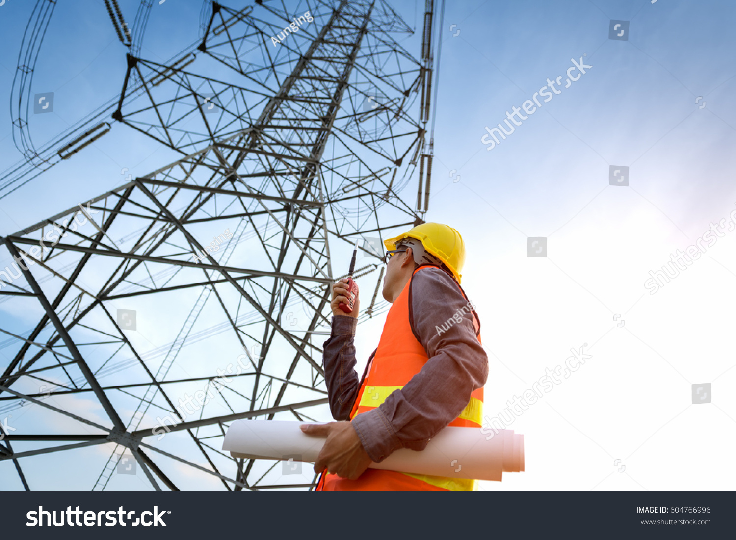 construction worker checking location site near to High voltage tower. #604766996