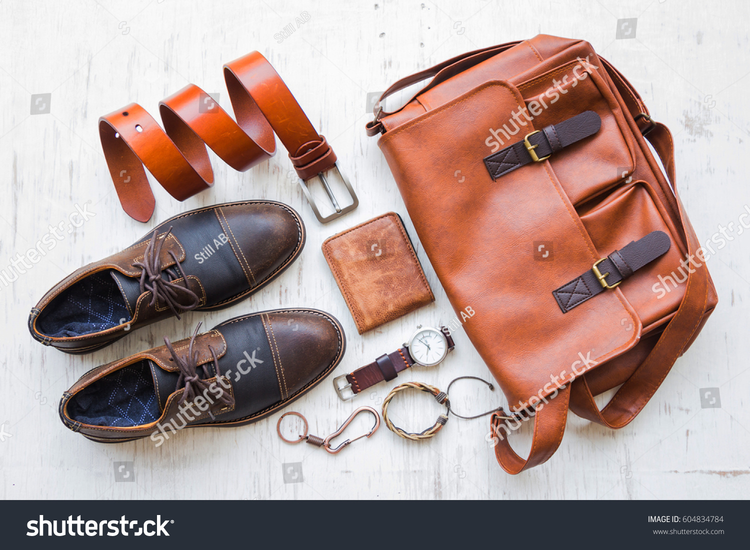 Men's casual outfits with leather accessories on white rustic wooden background, beauty and fashion concept #604834784