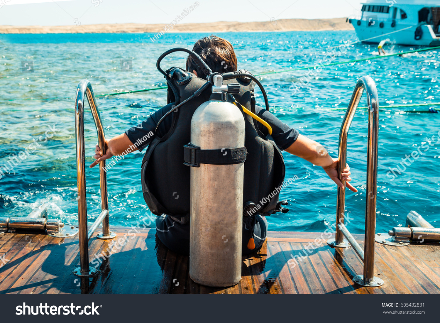 Scuba diver before diving. A diving lesson in open water. #605432831