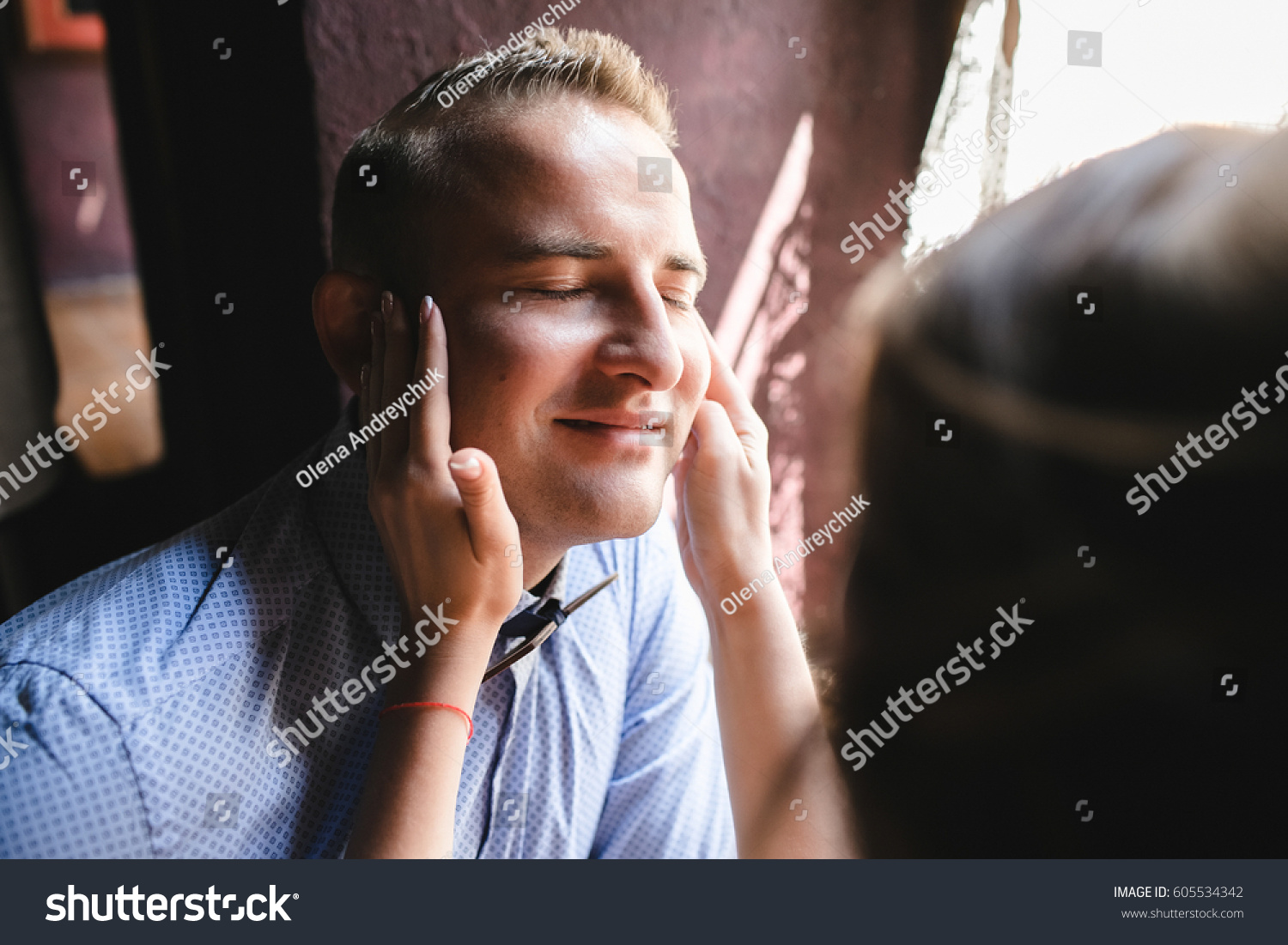 Man enjoys woman's touch sitting before the window #605534342
