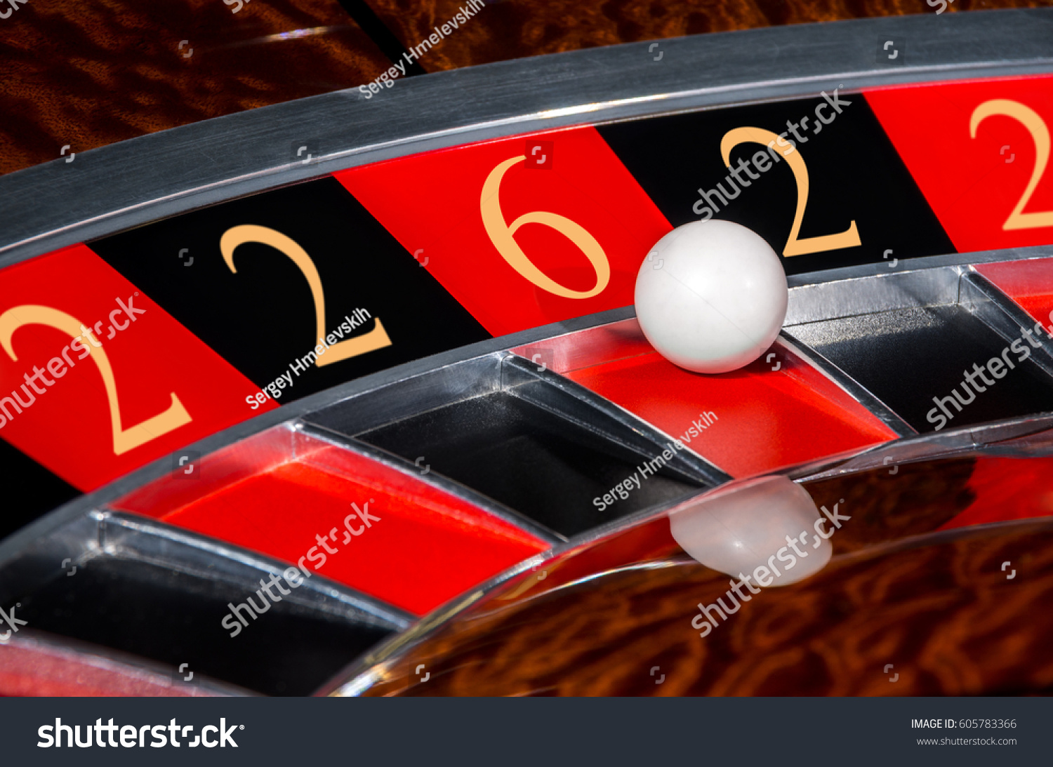 Concept of classic casino code 2-2-6-2-2 lucky numbers roulette wheel with black and red sectors and white ball #605783366