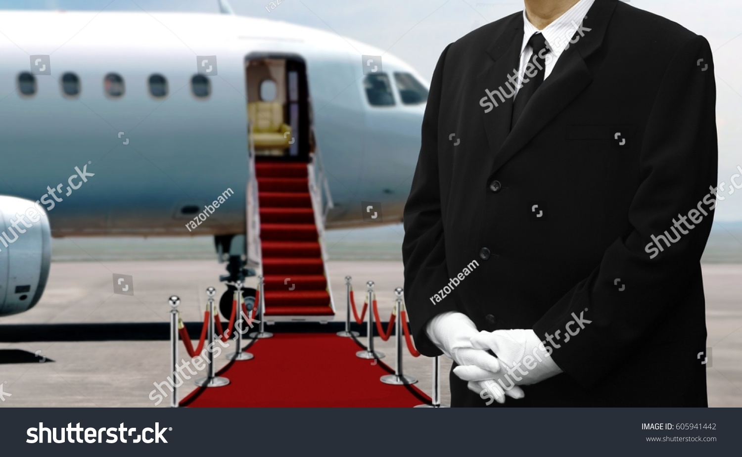 Man in black suits waiting next to private jet before departure #605941442