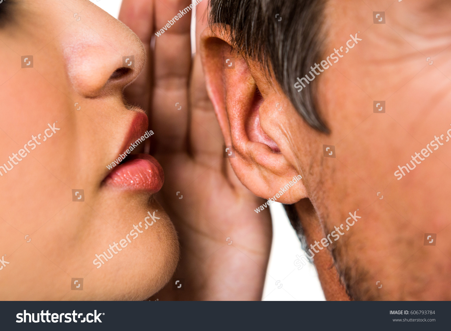 Close-up of woman whispering in man ear #606793784