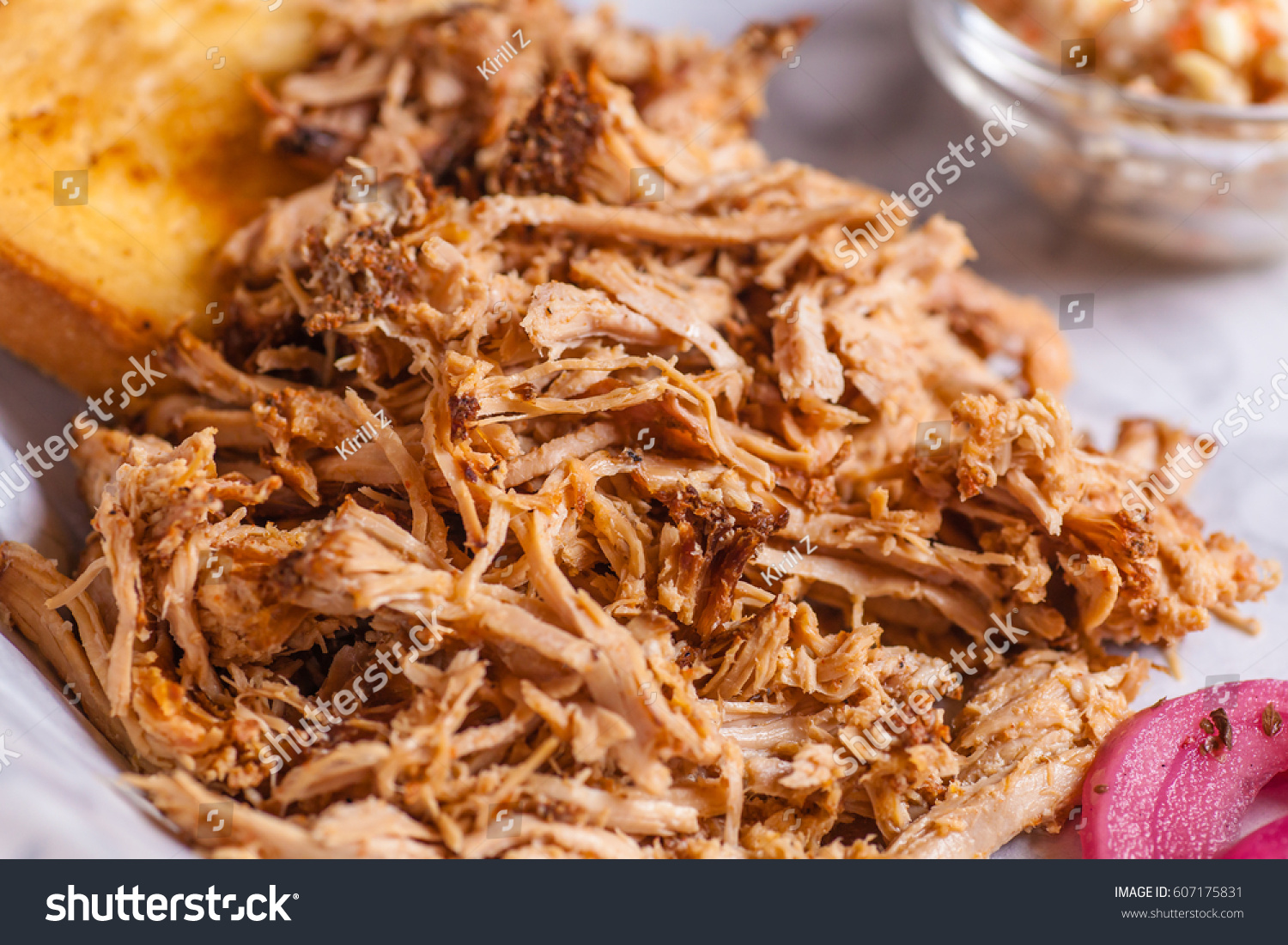 Close up shot of pulled pork fibers in a sandwich freshy served on a platter #607175831