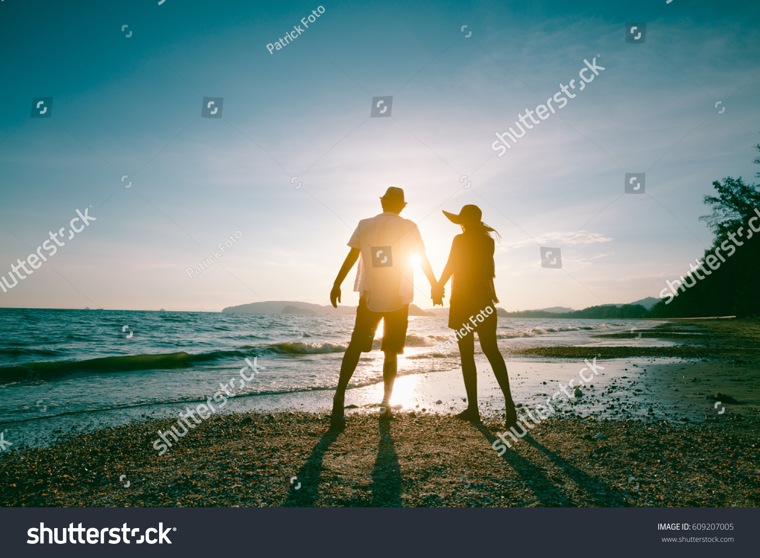 Romantic middle aged couple enjoying beautiful sunset walk on the beach travel vacation, Krabi Thailand #609207005
