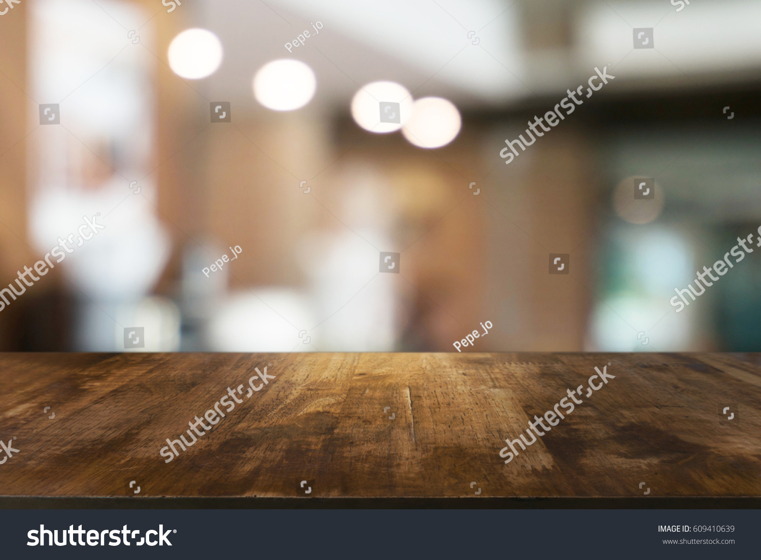 Empty wooden table in front of abstract blurred background of coffee shop . can be used for display or montage your products.Mock up for display of product #609410639