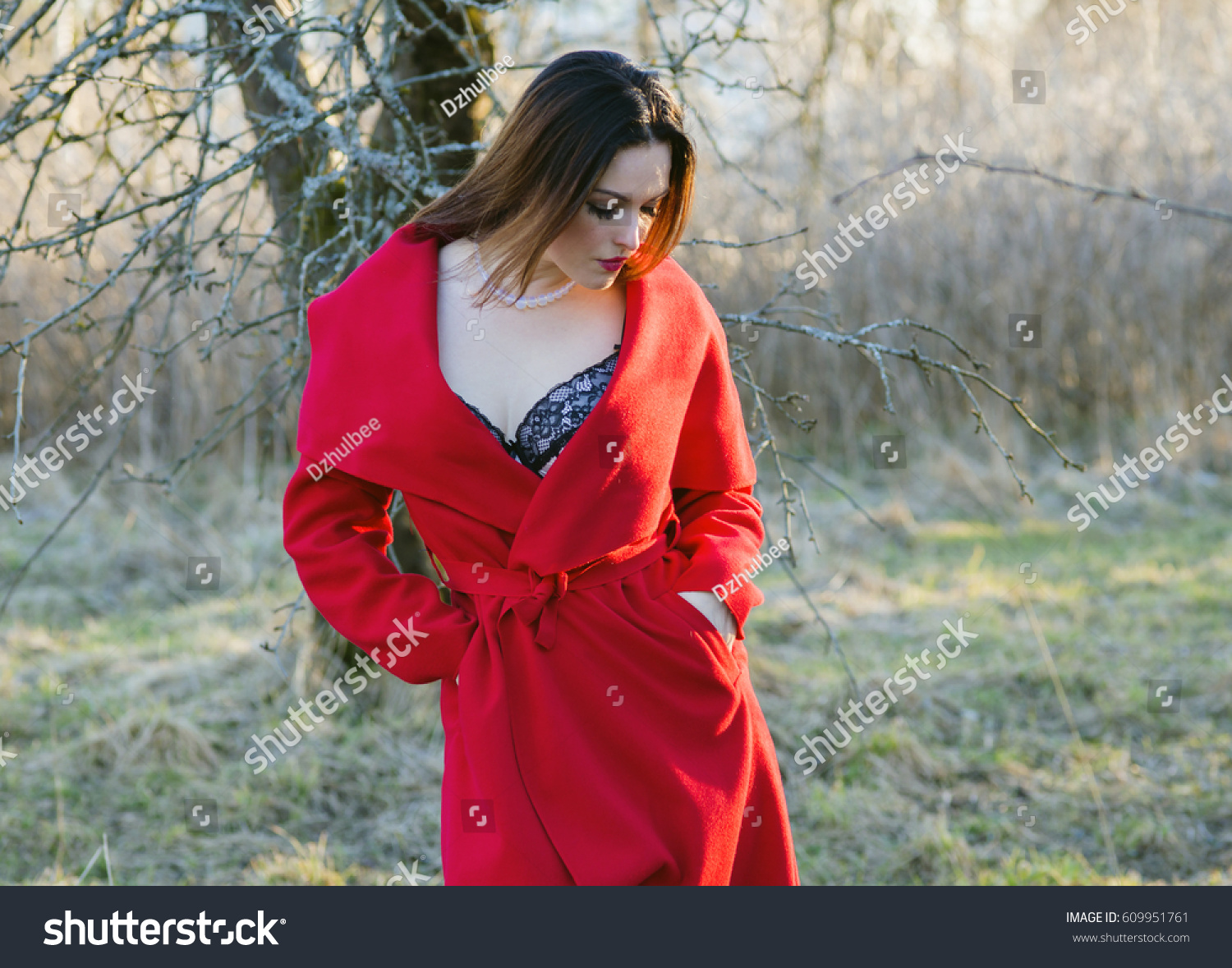 The sexual beauty in a red coat, the erotic nature #609951761