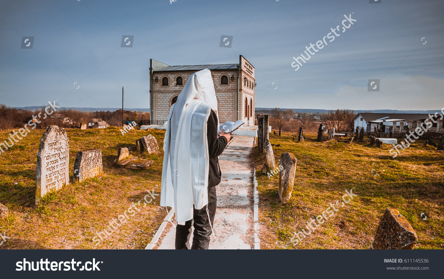 Jewish men prayer on the Holy gravesite of the Baal Shem Tov in Medziboz #611145536