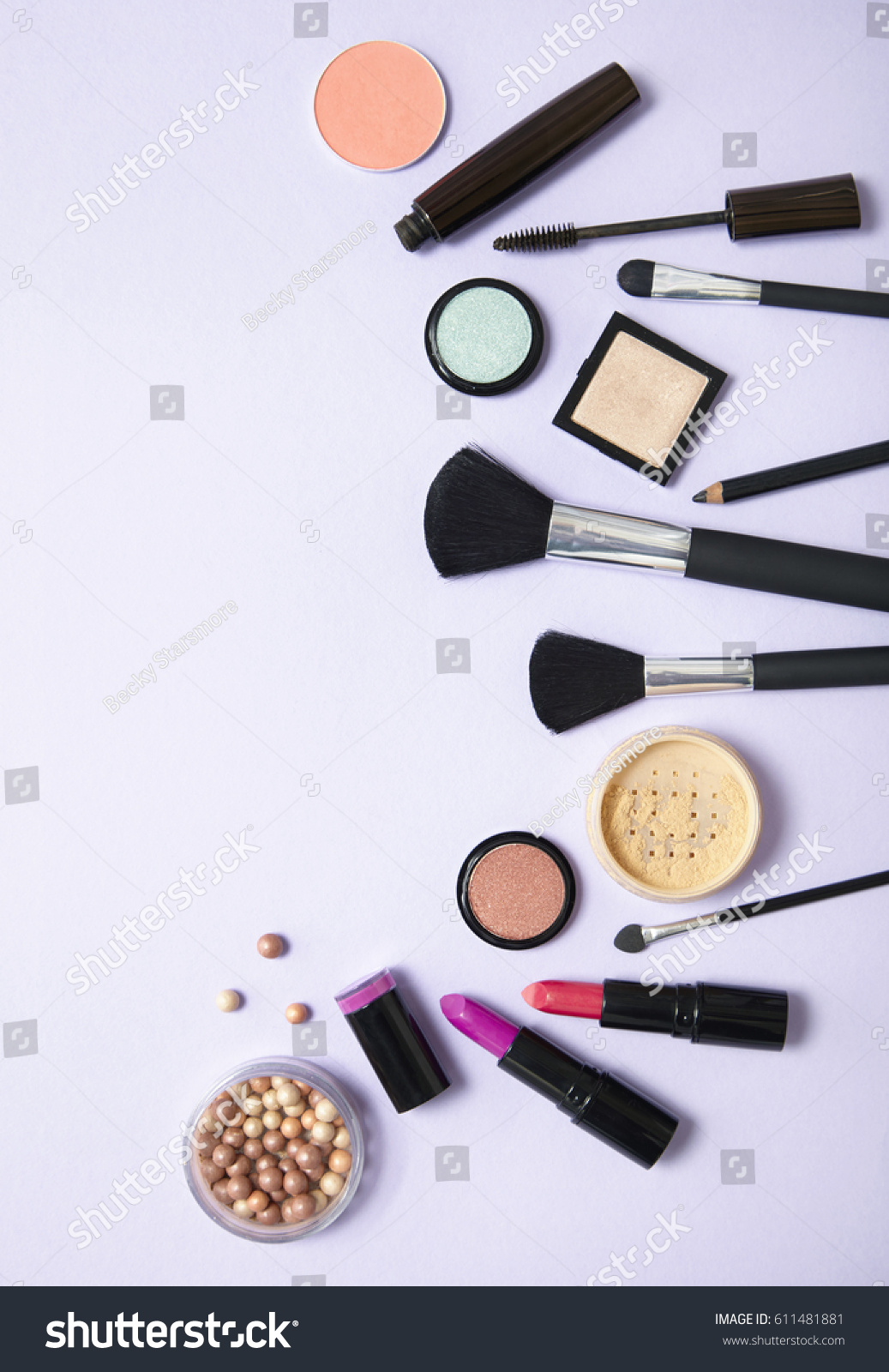 A collection of make up and cosmetic beauty products arranged on a pale purple background #611481881
