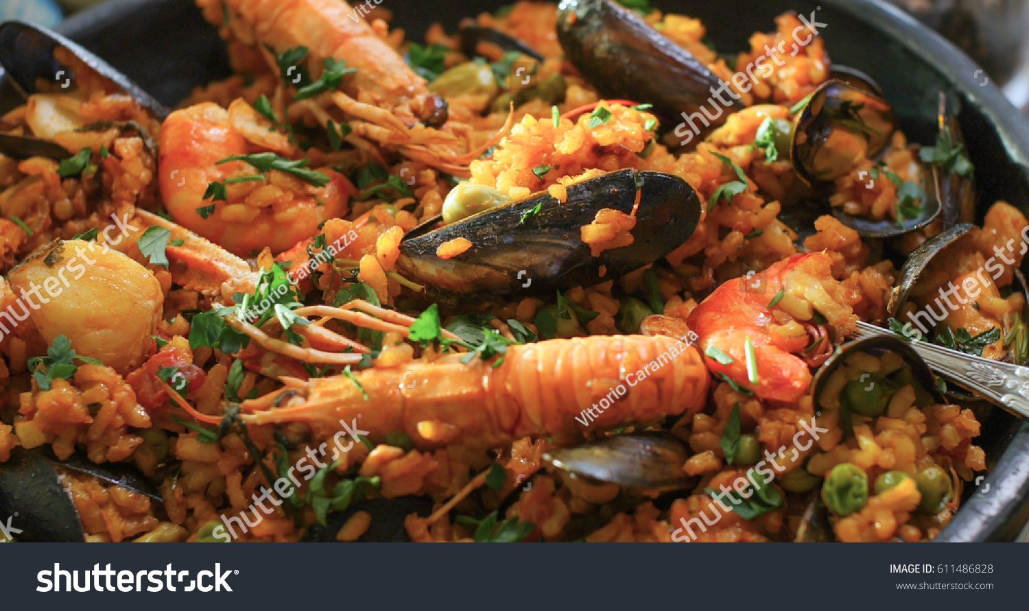 Extreme close up view of delicious Spanish seafood paella: mussels, king prawns, langoustine, haddock #611486828
