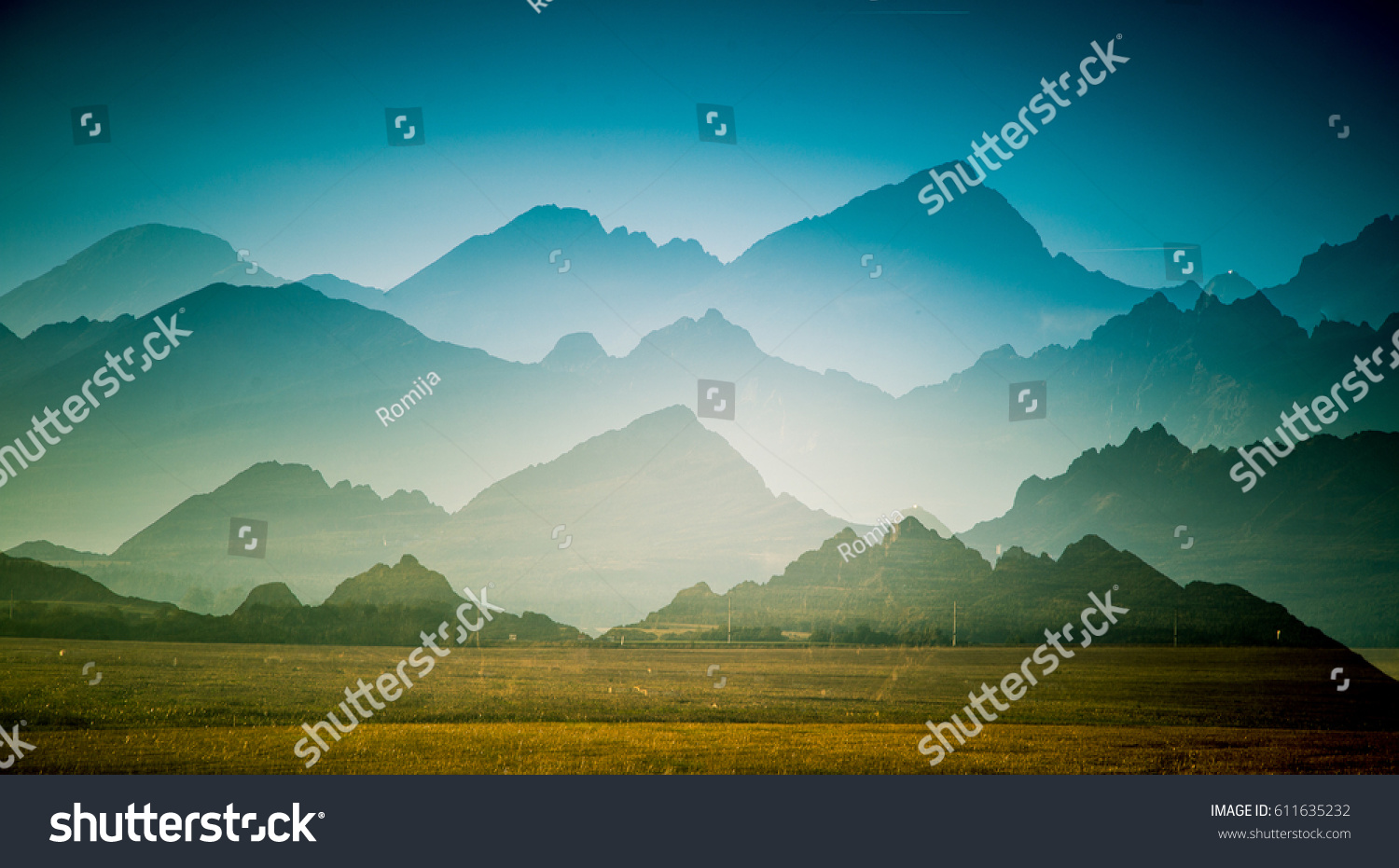 A beautiful, colorful, abstract mountain landscape with a hot summer haze in warm green tonality. Decorative, artistic double exposure. #611635232