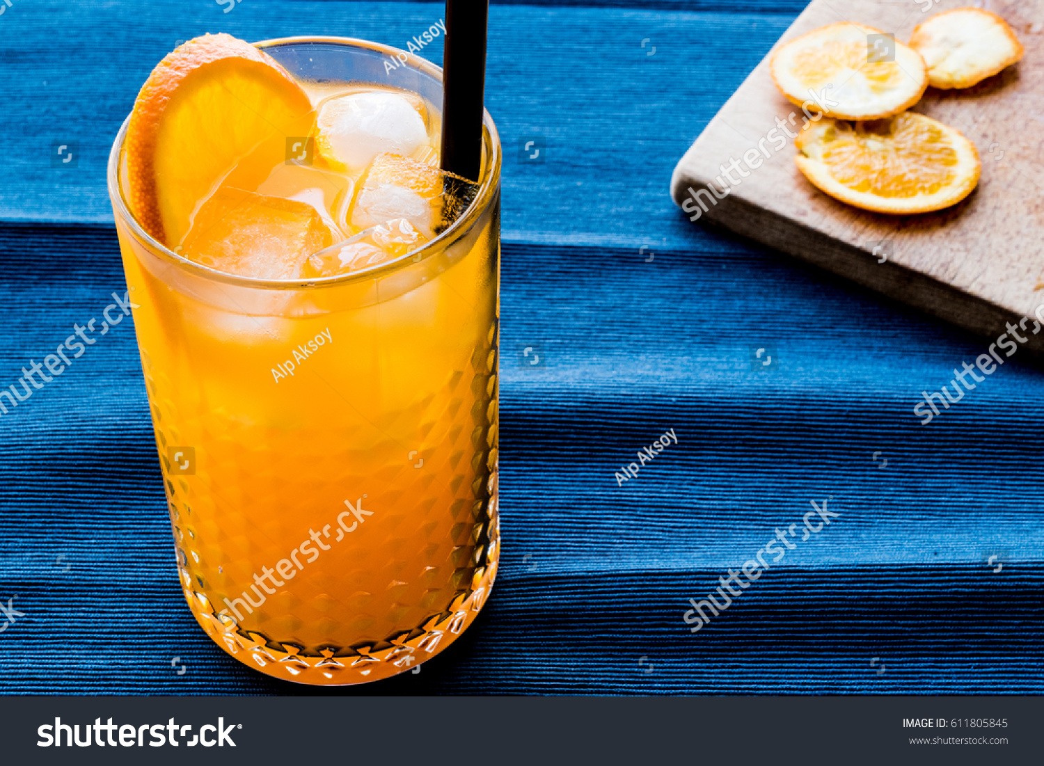 Orange Cocktail with ice cubes. #611805845