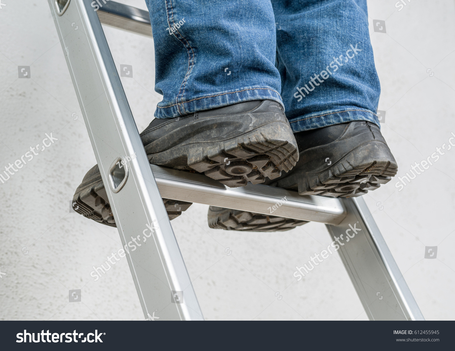 A man stands on a ladder #612455945