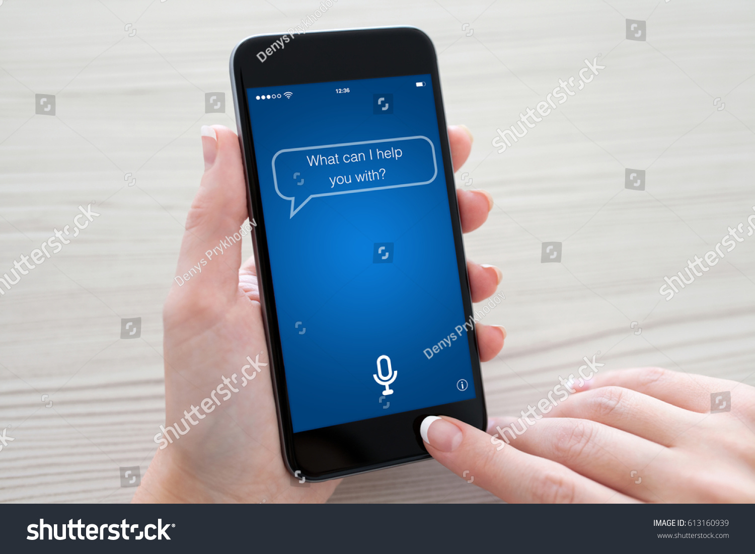 Women hands holding phone with app personal assistant on screen over table
 #613160939