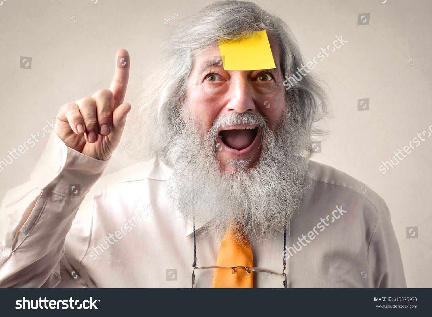 Excited elderly man with a sticky note on his forehead #613375973