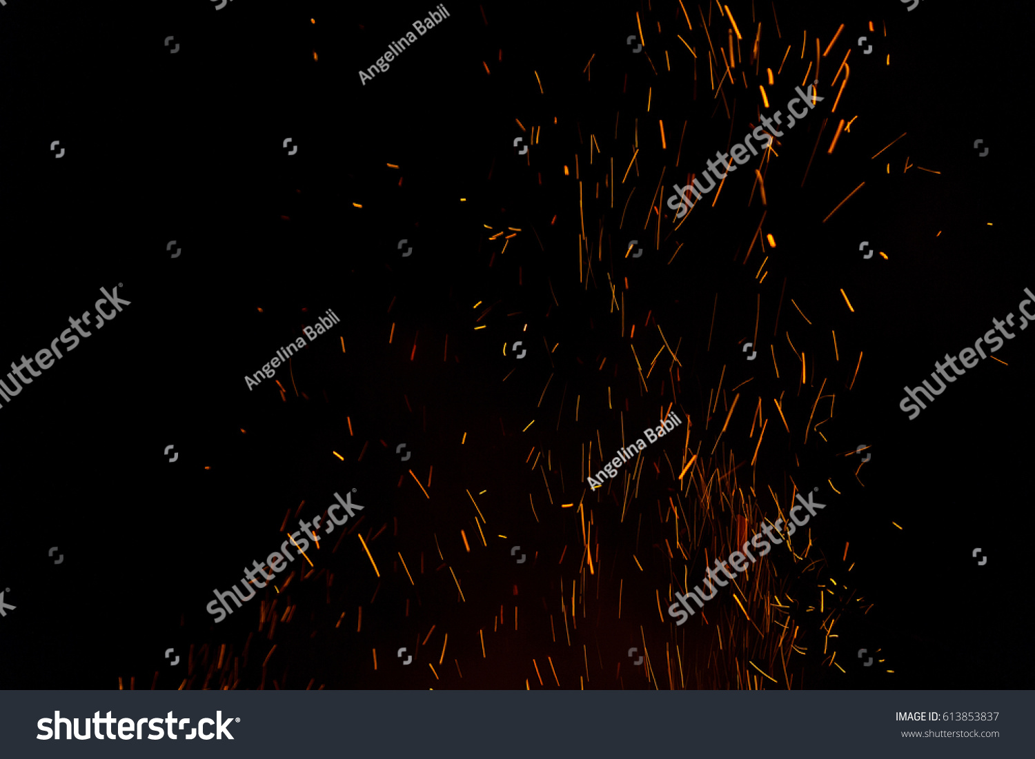 Photo of hot sparking live-coals burning, spark of bonfire. #613853837