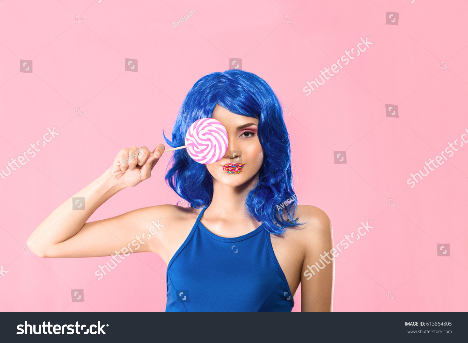Fashion young woman with sweet makeup holding lolipop in her hands #613864805