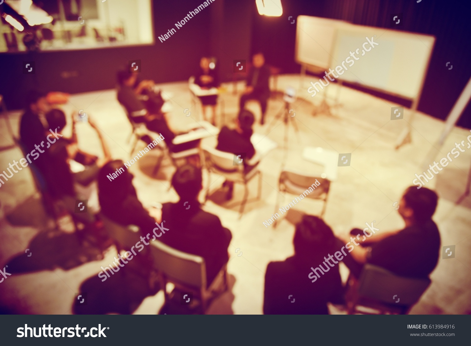 blurred image of group Business team People in black shirt Colleagues Teamwork sitting and stand, Meeting for planning project business in studio  Concept. vintage filter. #613984916
