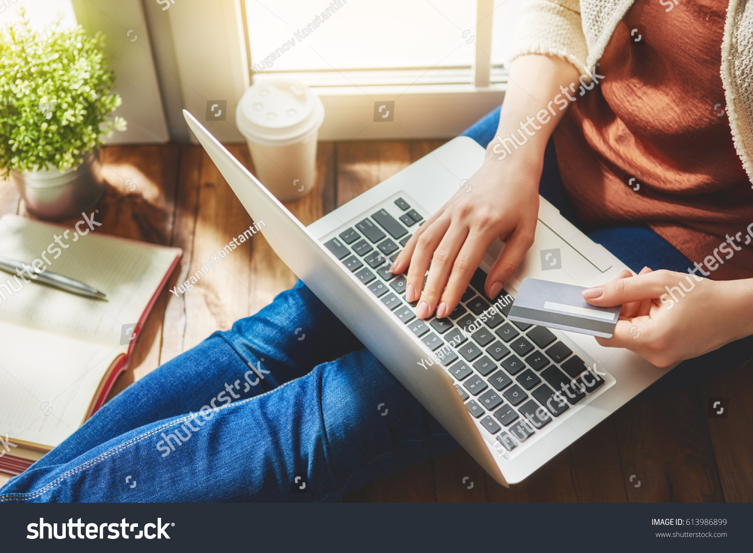 Woman is holding credit card and using laptop computer. Online shopping concept. Close up. #613986899